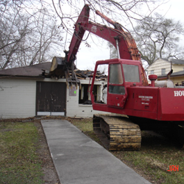 Excavator Demoing a House