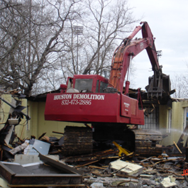 Excavator Crushing a House