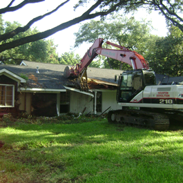 Excavator Tearing a House Down